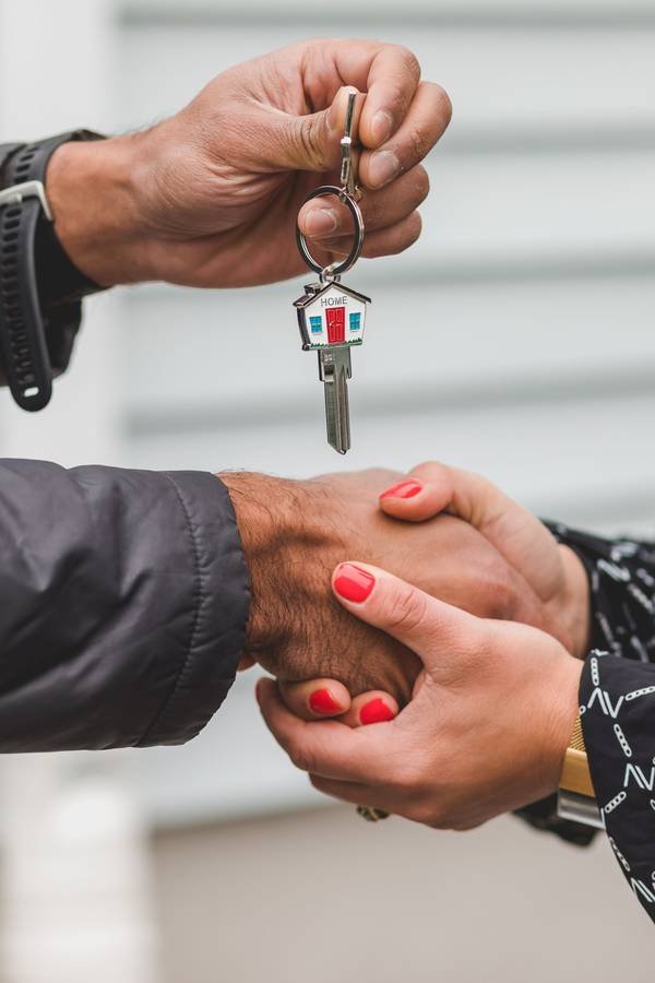 A handshake over a house key