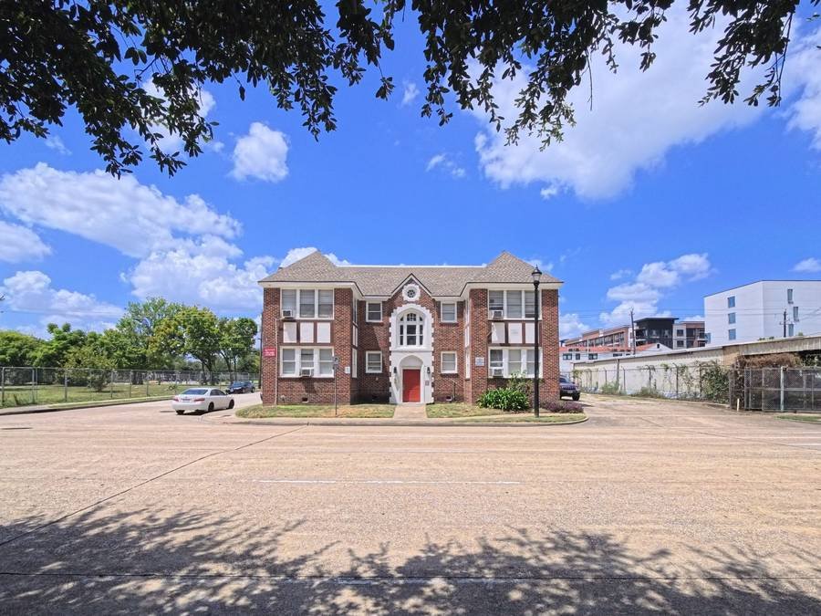 A small two-story brick multifamily building